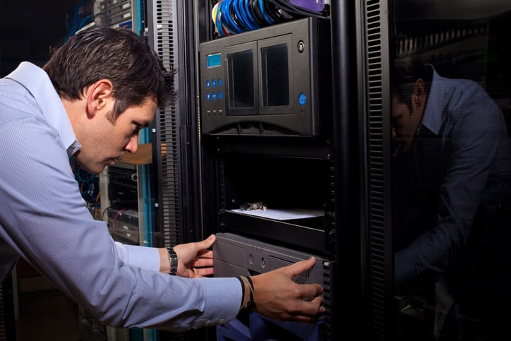 IT Systems Administrator Installing Computer Equipment in Server Room
